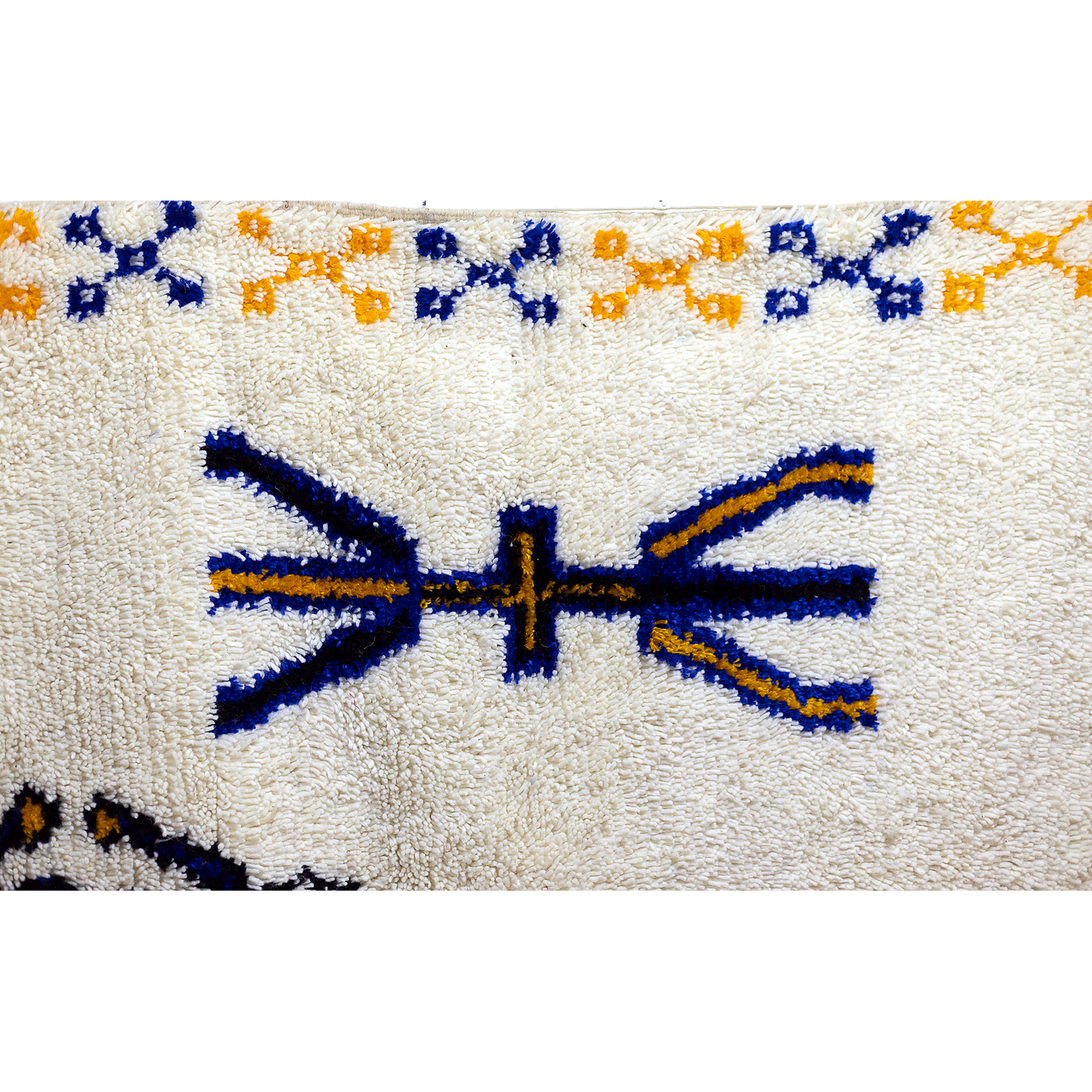 Corner of Azilal rug showing fringe and geometric motifs.