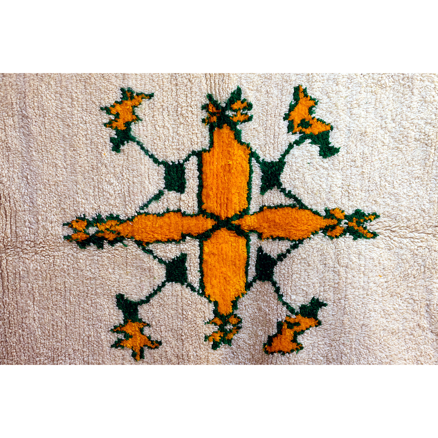 Central golden star motif on Moroccan Azilal rug, ivory wool base.