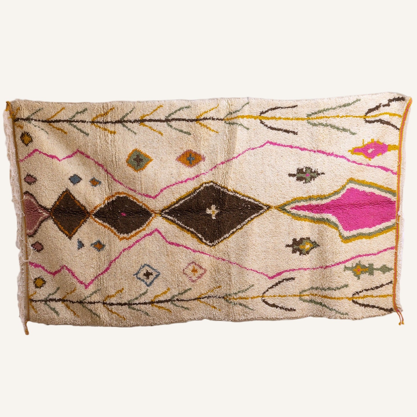 Full view of Azilal Moroccan rug with pink and brown diamond medallions on ivory field (150 × 260 cm)