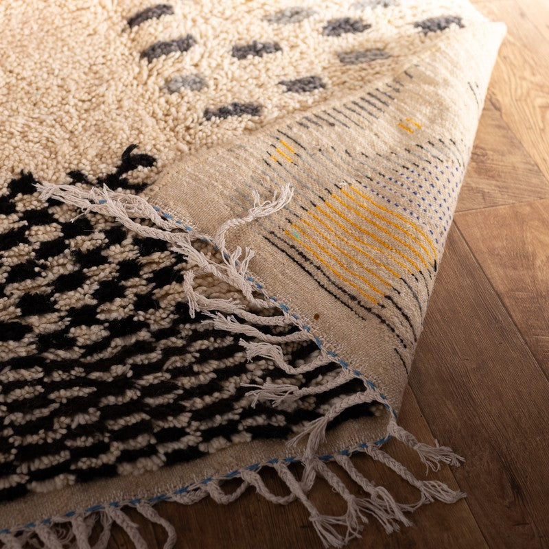 Handwoven Moroccan Azilal rug with colorful Amazigh geometric motifs in wool