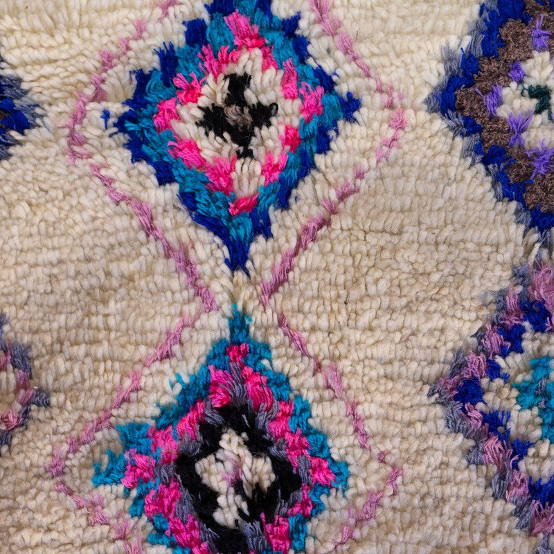 Colorful Azilal rug with bright red, blue, yellow, and green tribal patterns