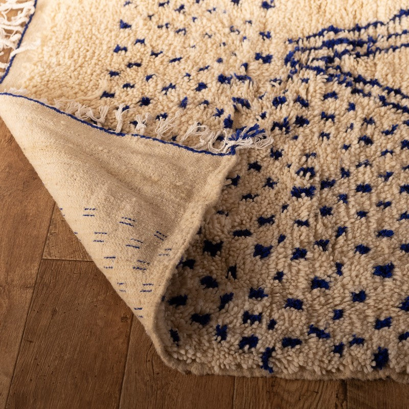 Neutral ivory Moroccan rug with minimalist Amazigh motifs and wool texture